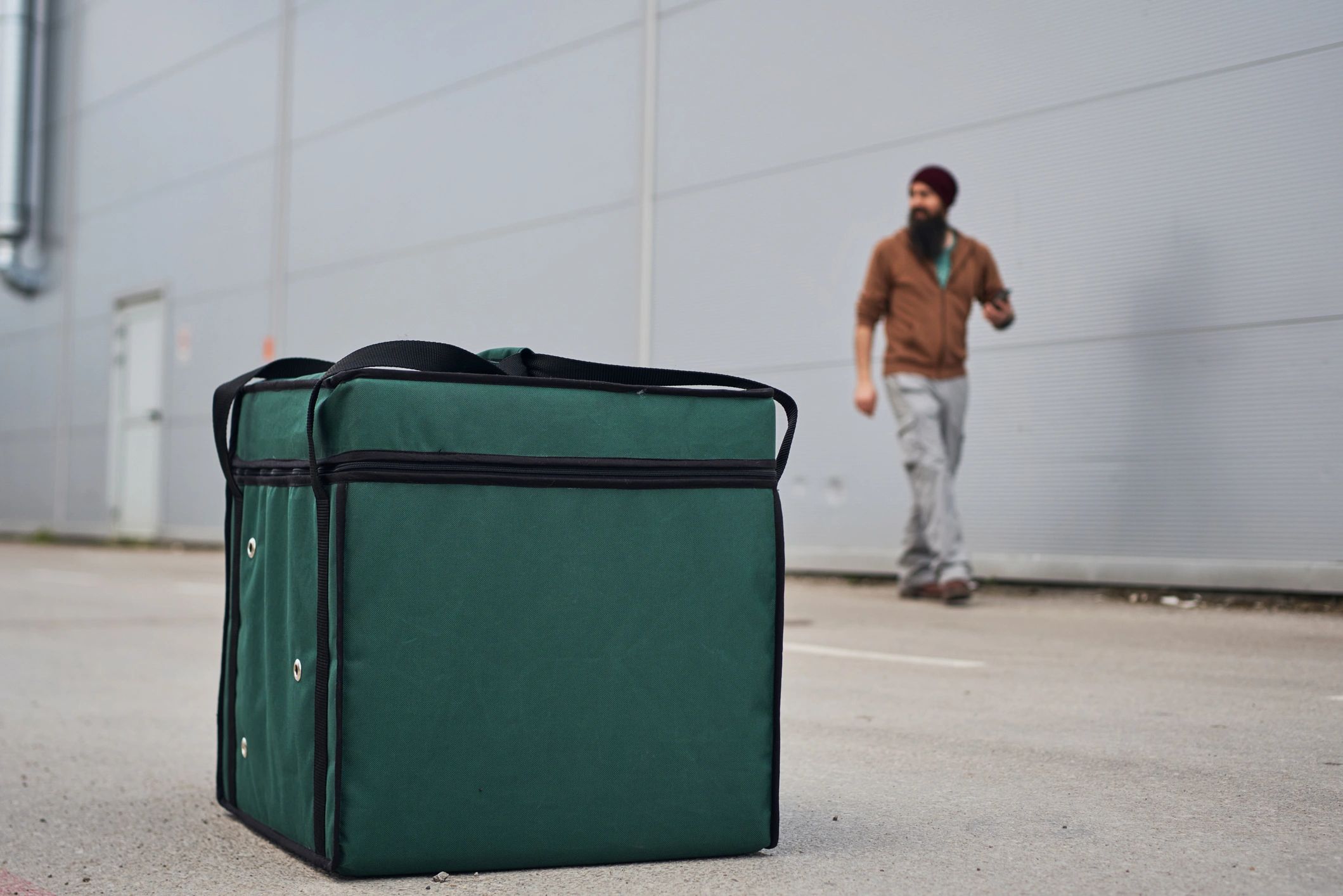 Courier with delivery bag in the city