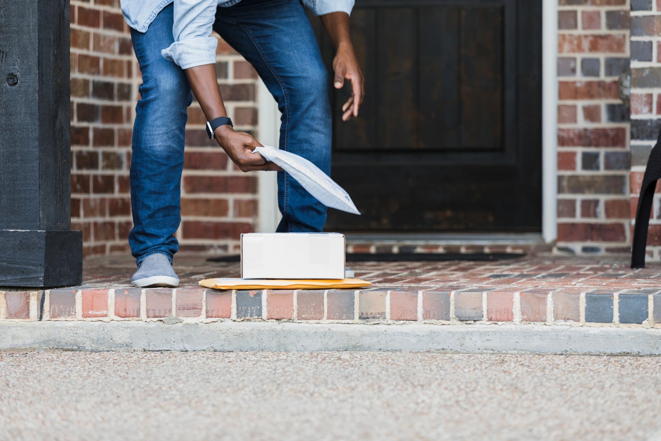 Discreet package pickup on a doorstep representing discreet delivery