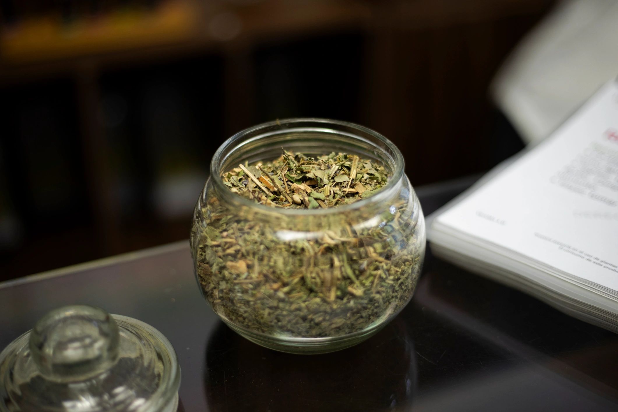 Premium cannabis in a glass jar on a dark background